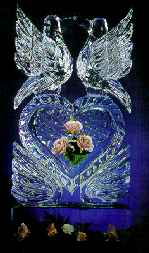 Elegant ice sculpture of an ice heart with your love ones favorite flowers frozen in time.